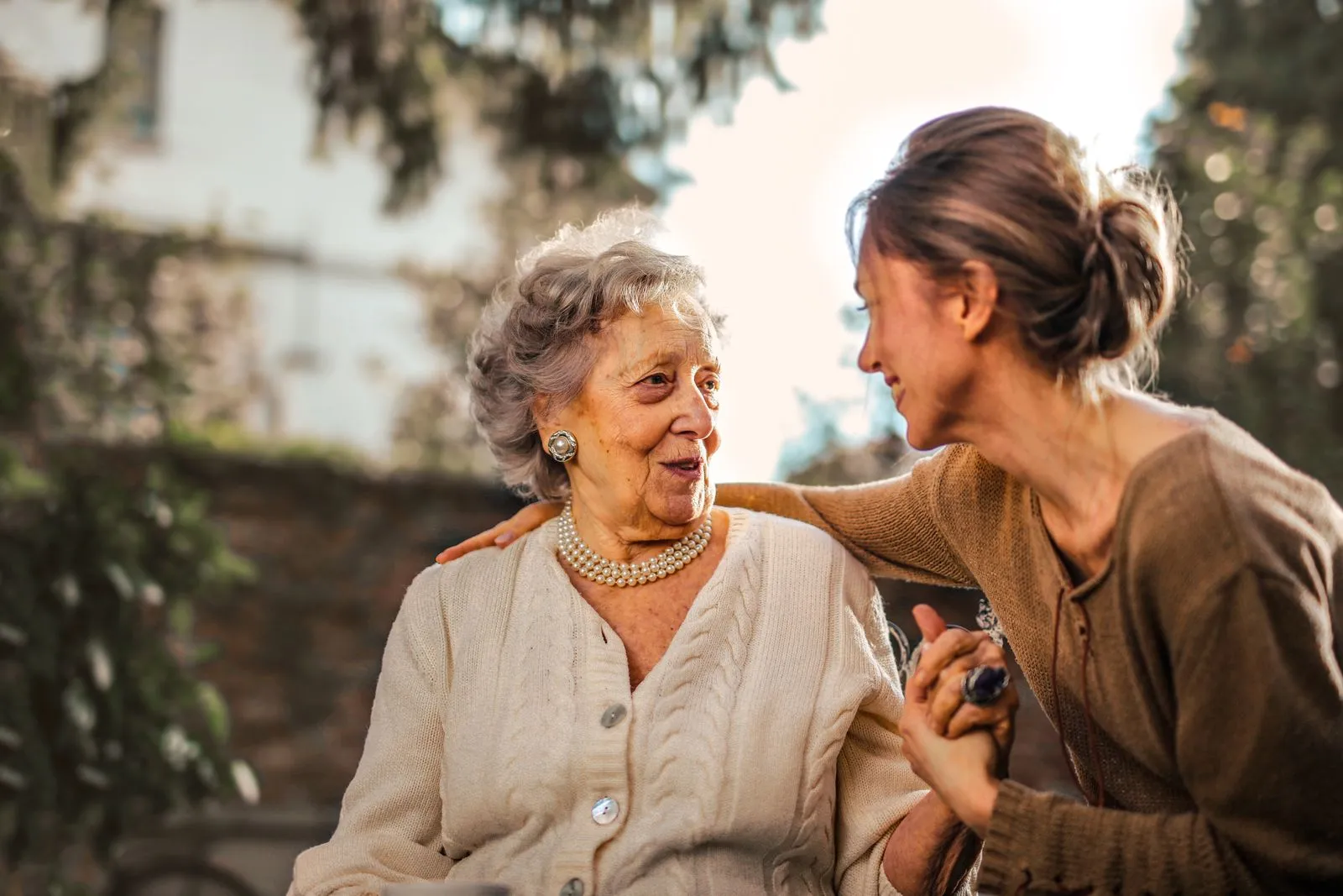 Young woman keeping an elderly woman company
