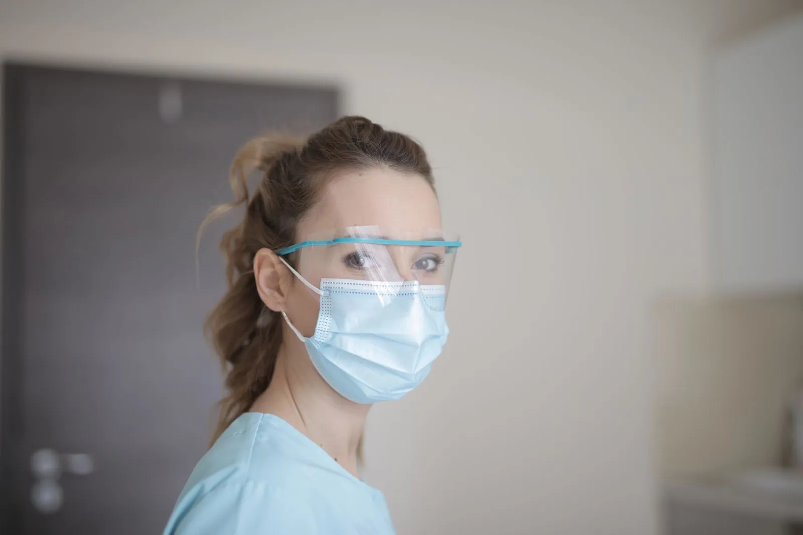 Healthcare worker wearing a face mask and safety glasses