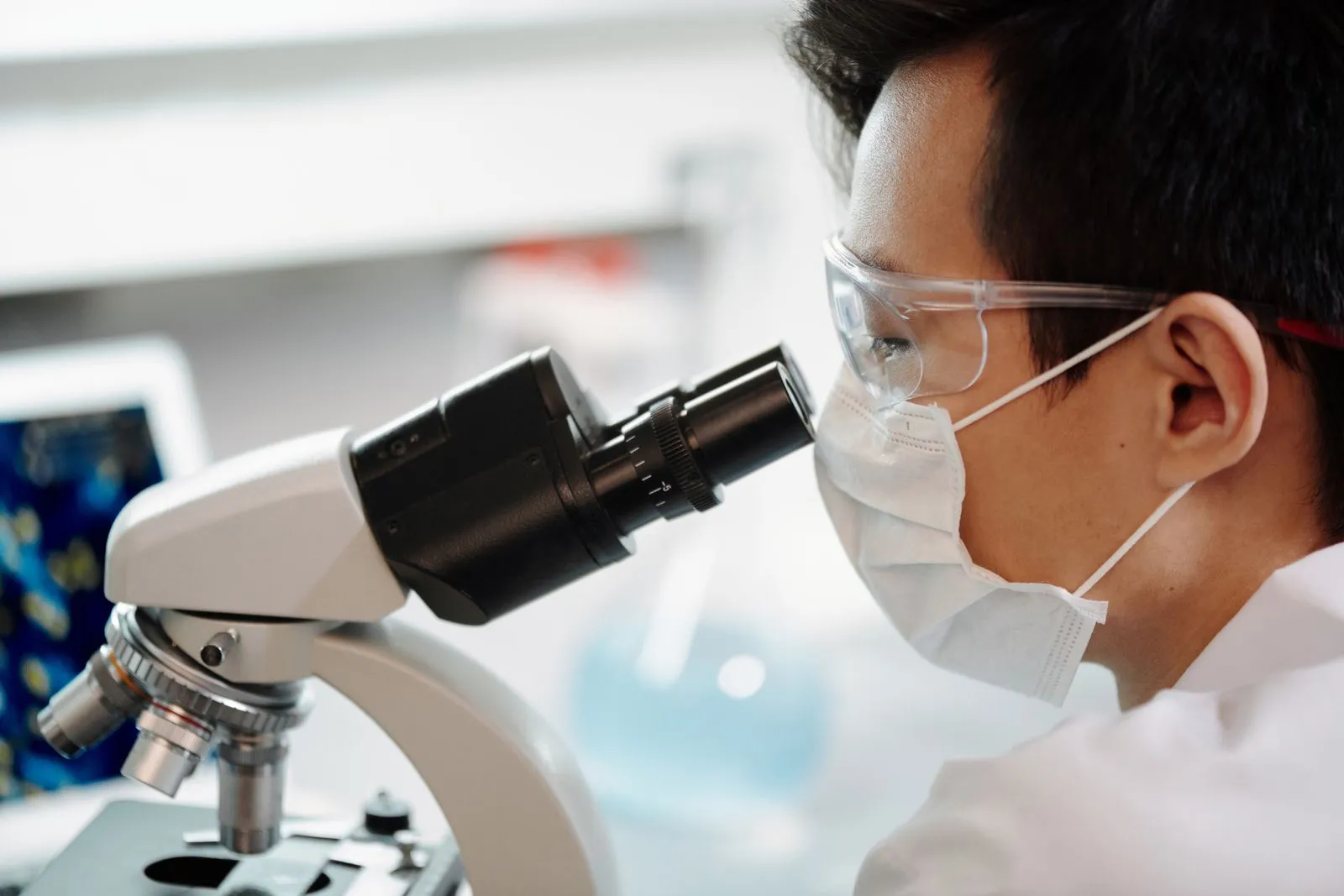 Researcher looking through a microscope