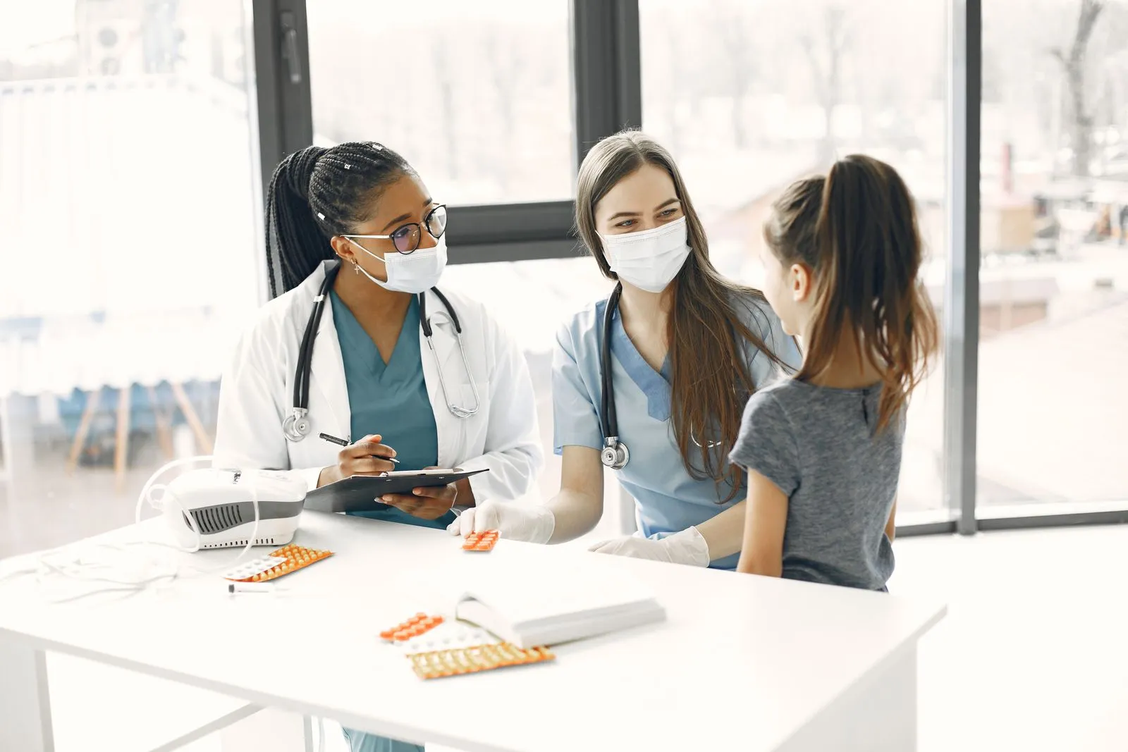 Doctors talking with a young girl at the clinic