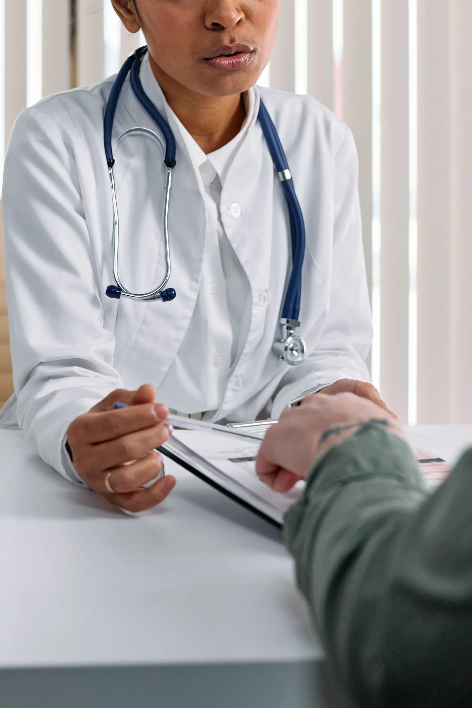 Doctor in a white coat with a patient